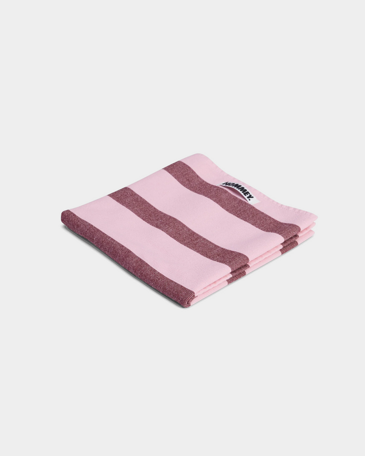 striped pink and red tea towel on white background 