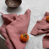 rose pink napkins sitting on a marble table