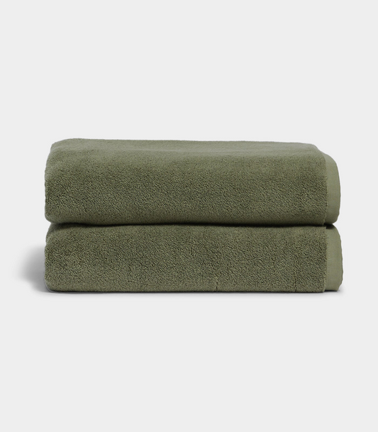 dark green towel sitting on white background