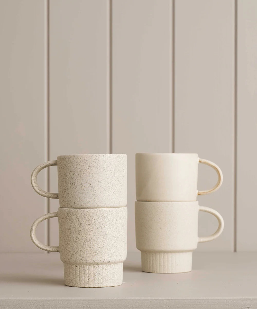 white mugs sitting on a wooden shelf 