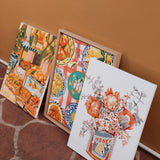various paint by numbers kits sitting against a wall