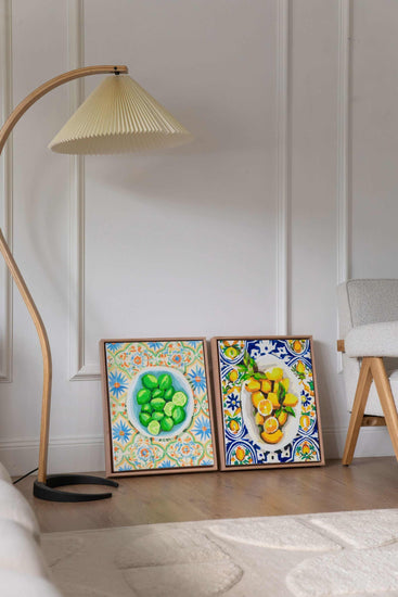 wall art of a bowl of lemons and a bowl of limes sitting side by side against a wall