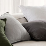 different coloured linen cushions scattered on a couch