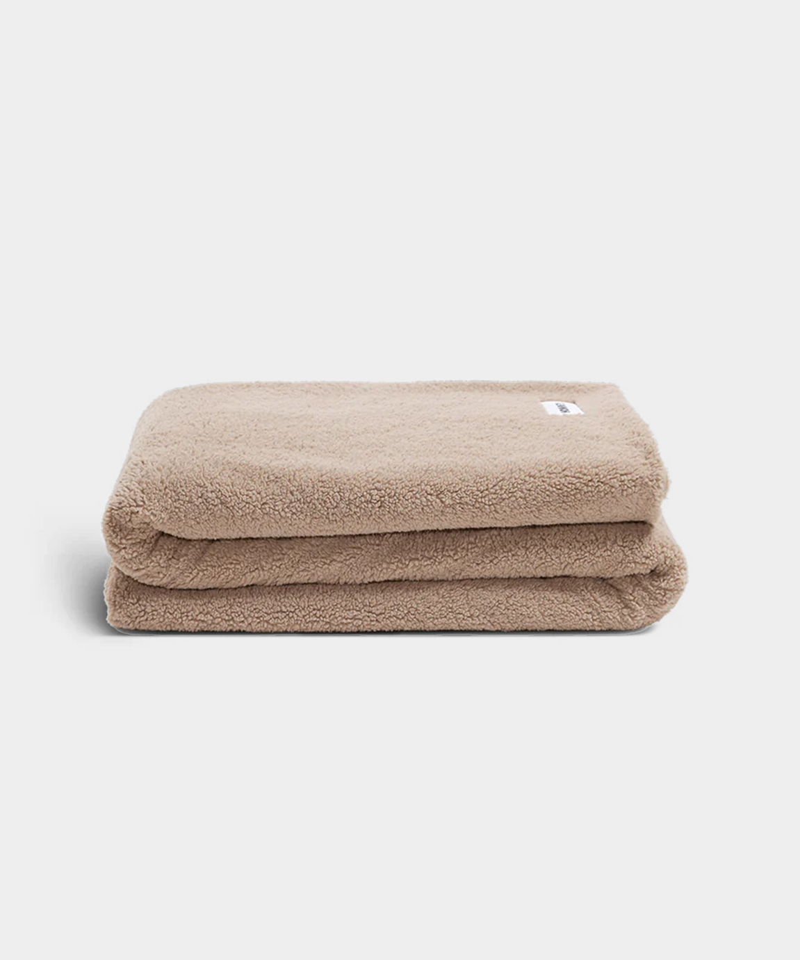beige throw blanket on white background