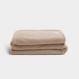 beige throw blanket on white background