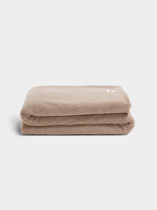 beige throw blanket on white background